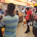An activist helping inform about phyiscal distancing in Shoprite Menongue